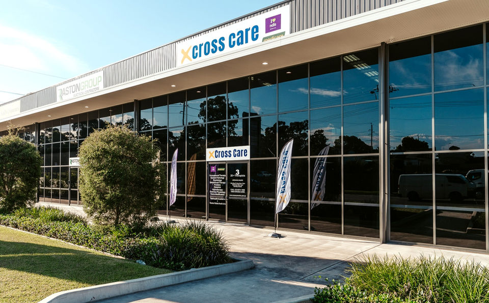 Cross Care Smithfield clinic exterior with signage and feather banners